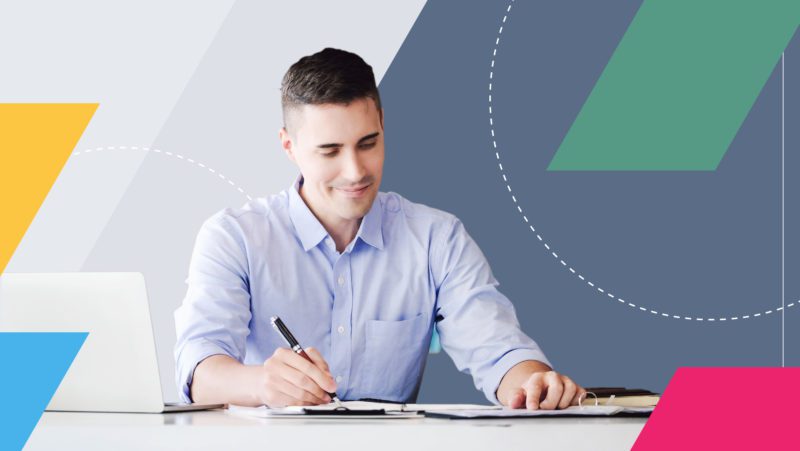 product manager smiling at documents and planning ahead