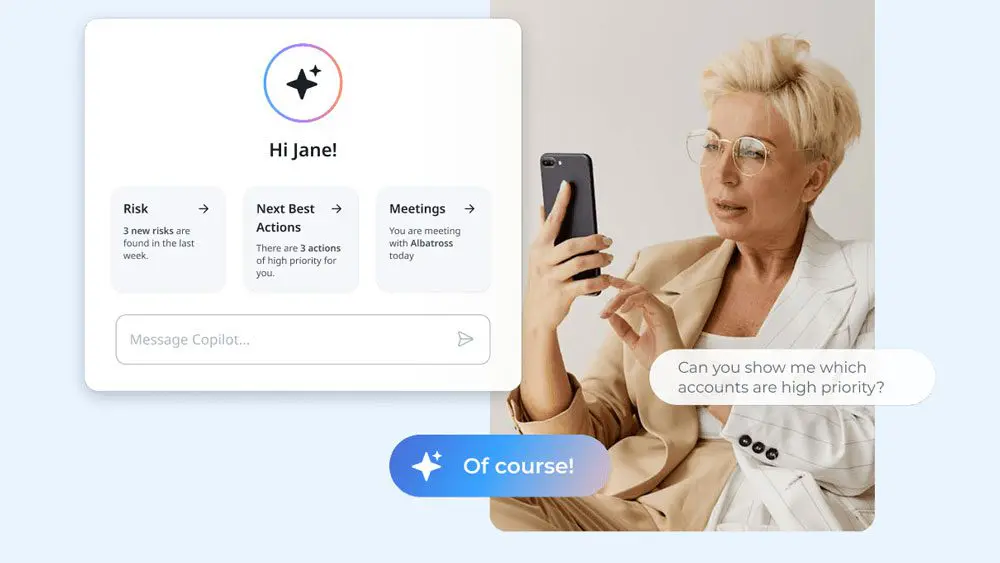 A blonde woman in glasses and a beige suit sits holding a smartphone. On the left, a digital assistant interface greets "Hi Jane!" and lists tasks like Net Revenue Retention, next best actions, and meetings. A speech bubble reads, "Can you show me which accounts are high priority?.