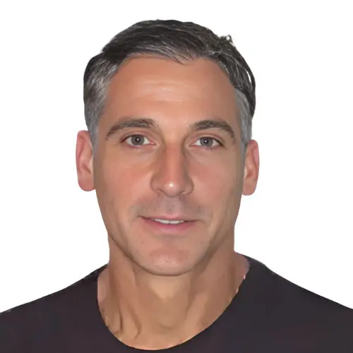 Ori Entis, a man with short, dark hair, wearing a dark shirt, poses against a plain white background, looking directly at the camera.