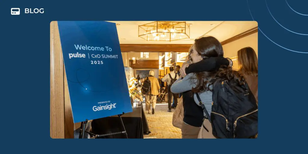 A woman with a backpack hugs another person near a sign that reads "Welcome To CxO Summit 2025 Presented by Gainsight," capturing the spirit of connection and pragmatism in the brightly lit conference hallway.