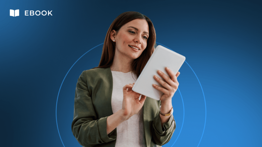 A woman in a green jacket smiles as she looks at a tablet, exploring the CE Toolkit with guidance from an Academy Advisor.