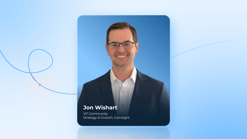 A man in a dark suit and glasses smiles at the camera. Text reads: “Jon Wishart, VP Community Strategy & Growth, Gainsight and Community Pros expert.” The background is blue with a curved line design.