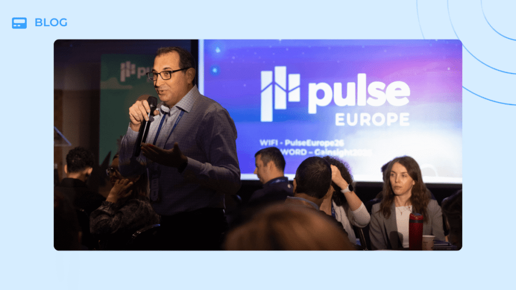 A man speaks into a microphone in front of a Pulse Europe 2026 conference screen about the agentic economy.